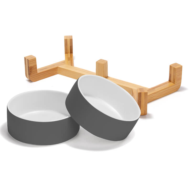separate placed 2 grey-white clashing ceramic dog bowls and their bamboo stand
