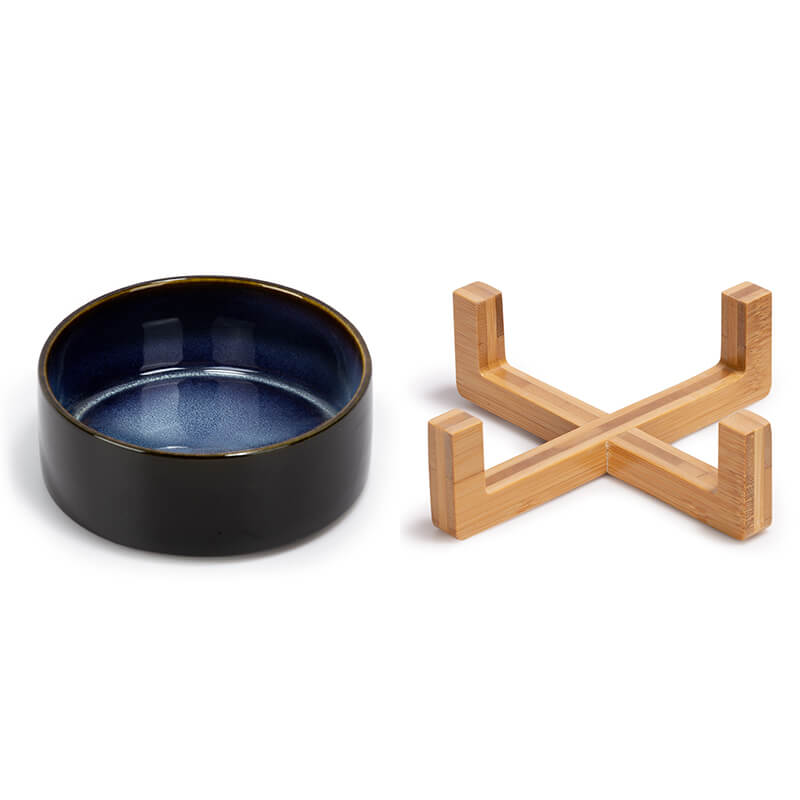 a starry sky patterned ceramic dog bowl and its bamboo stand are placed separately