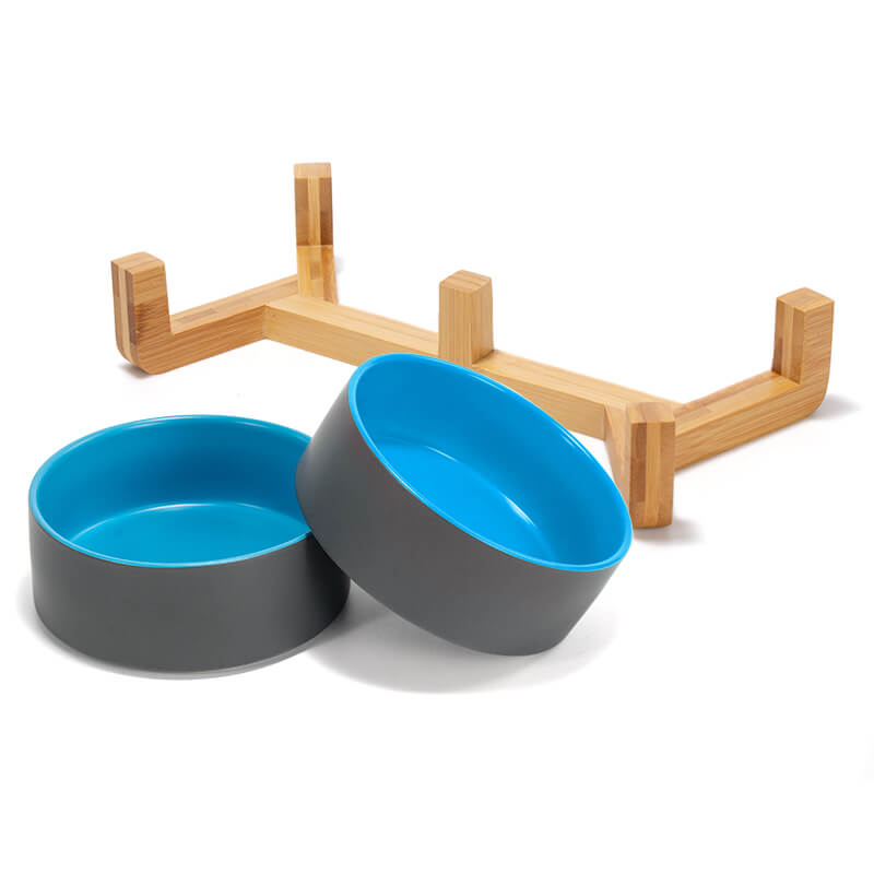 two grey-blue clashing ceramic dog bowls and their bamboo stand