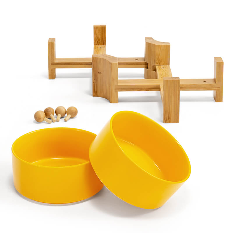 2 yellow dog bowls and the stand with bamboo balls that can pad up the bowl