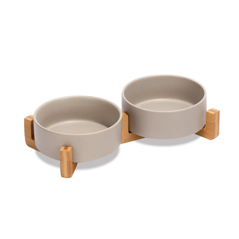 two cute grey dog bowls as a set on the bamboo stand