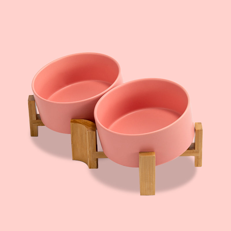 side view of a pink 15° tilted ceramic pet bowl set in the pink ground