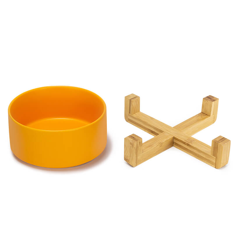 a cute yellow ceramic dog bowl and its bamboo stand are placed separately