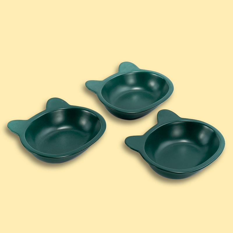 three neatly placed lovely green cat-shaped cat dishes in the yellow background