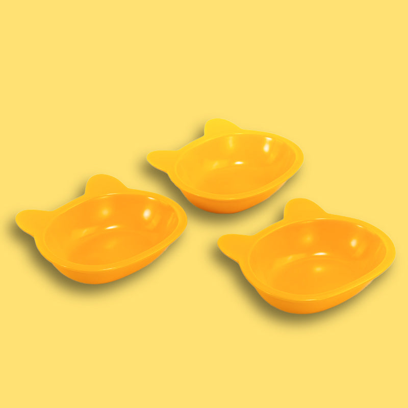 three neatly placed lovely yellow cat-shaped cat dishes in the yellow background