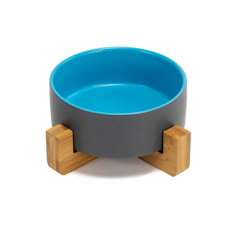 front view of the ceramic dog bowl with gray exterior and blue interior colors on the stand