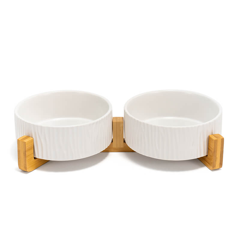 the front view of two white bark-patterned dog bowls on the stand