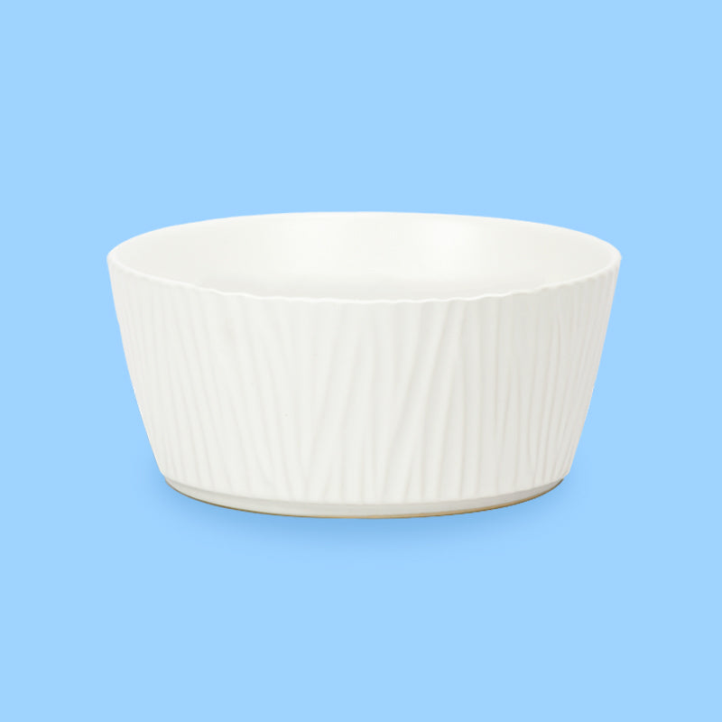 the front view of the bark-patterned large white ceramic dog bowl in the blue background