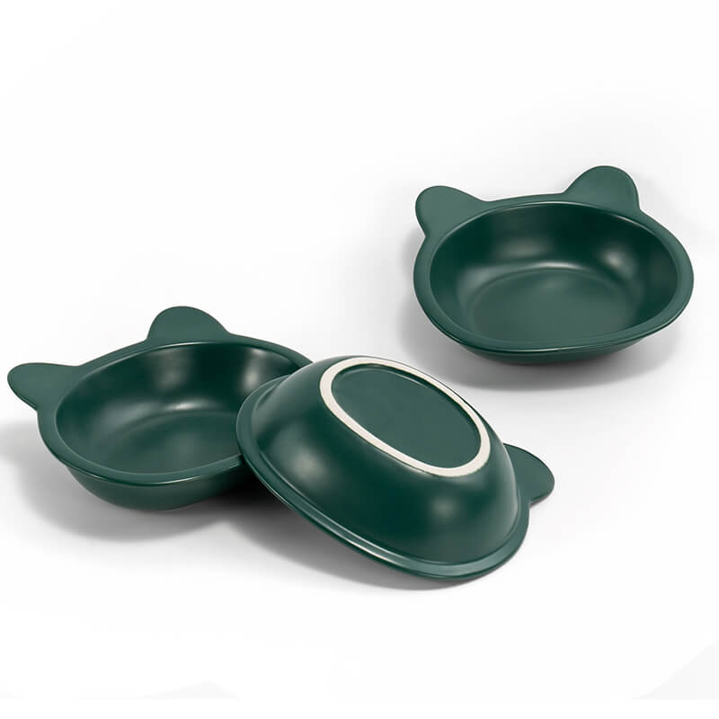 two front-facing, and one bottom-facing placed green ceramic cat-shaped dishes