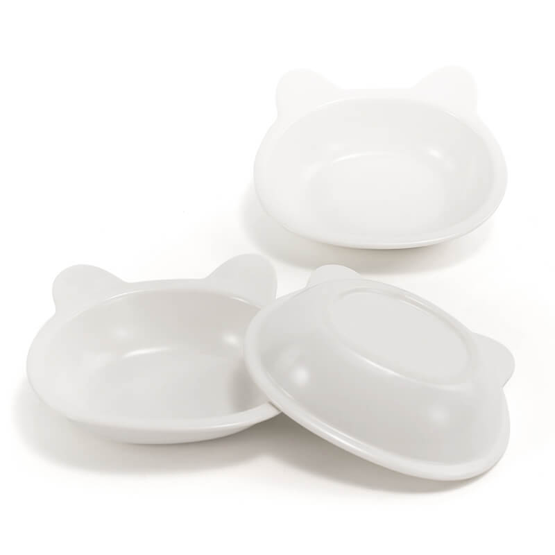 two front-facing, and one bottom-facing placed white ceramic cat-shaped dishes