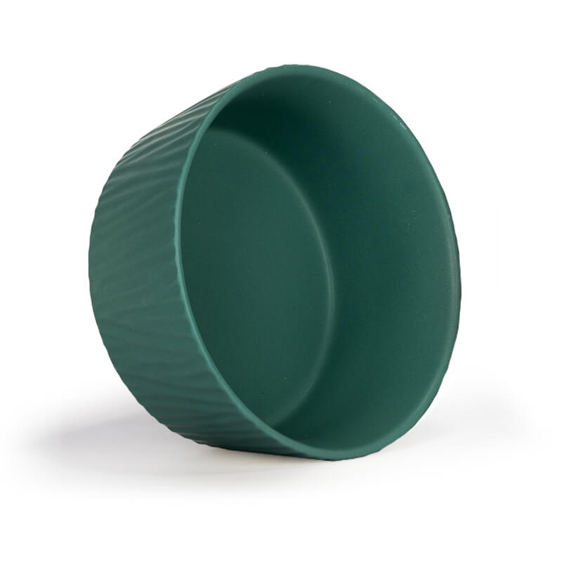 an upright-placed large green dog bowl with bark pattern
