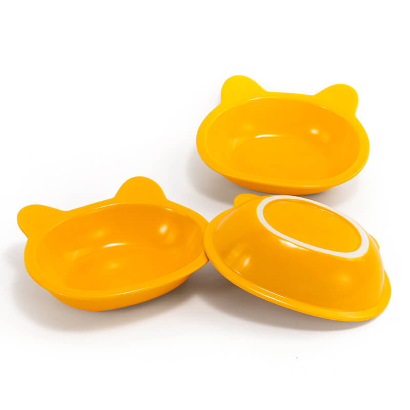two front-facing, and one bottom-facing placed yellow ceramic cat-shaped dishes