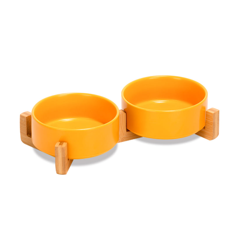 two cute yellow dog bowls as a set on the bamboo stand